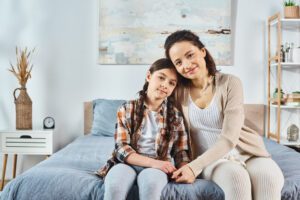 A mother and daughter standing together, reflecting on growth and development, with I Grow Clinic specializing in pediatric growth evaluation and bone age analysis.