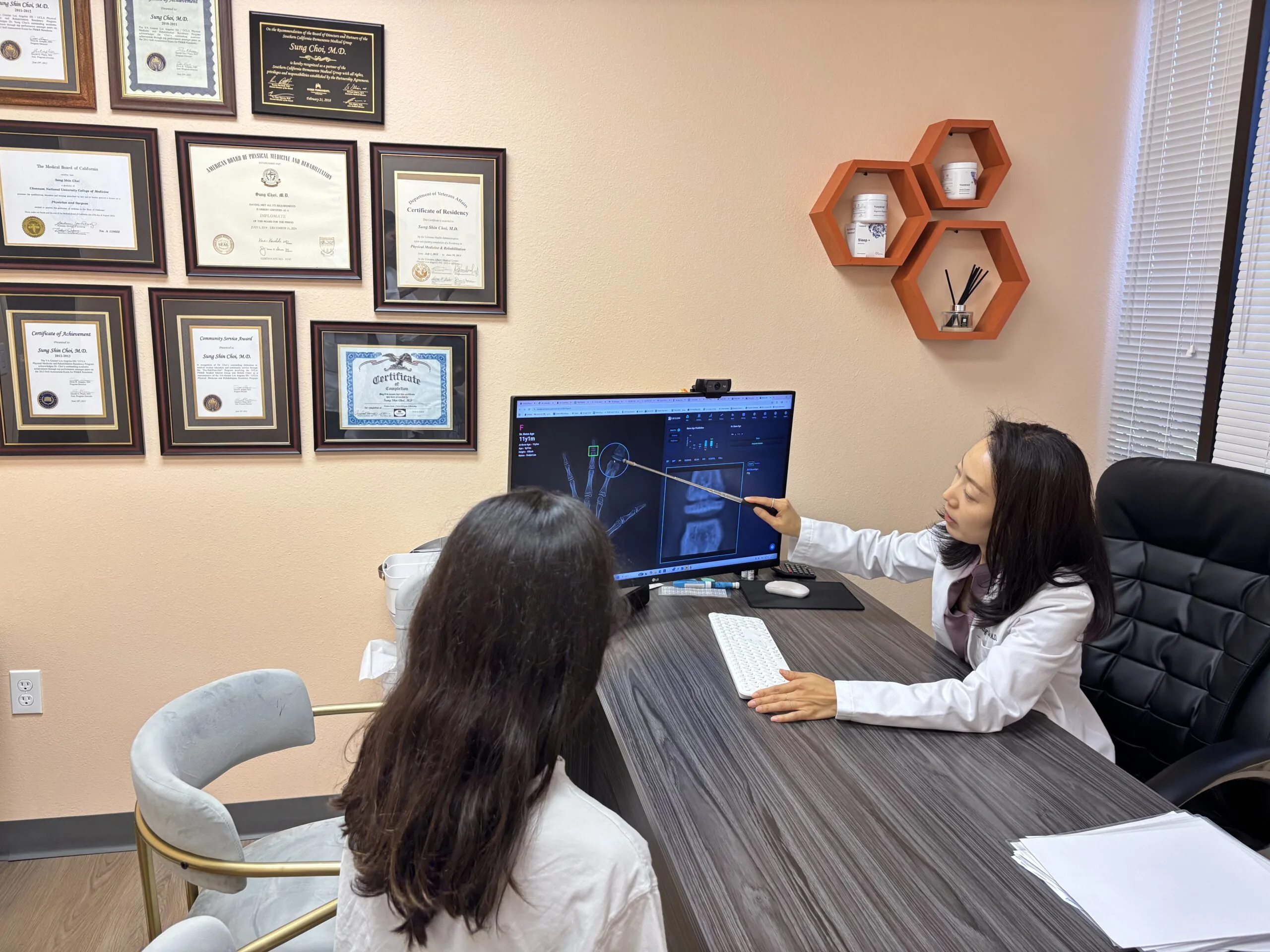 Physician explaining a childâ€™s bone growth X-ray to a parent during a growth evaluation consultation.