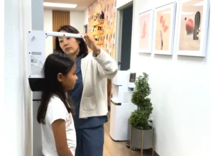 At I Grow Clinic in Fullerton, a healthcare professional carefully measures a child's height as part of a comprehensive safety protocol to monitor growth hormone therapy and minimize potential side effects.
