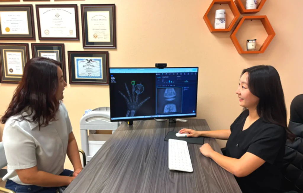Sunjo Chung, FNP at I Grow Clinic discussing bone age results with a family during a personalized growth consultation.