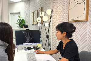 Pediatric growth specialist NP Yuri reviewing bone age results with a patient at I Grow Clinic Fullerton