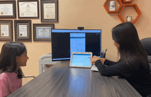 Nurse practitioner Sunjo Chung FNP reviewing a height percentile growth chart with a young patient at I Grow Clinic in Fullerton California