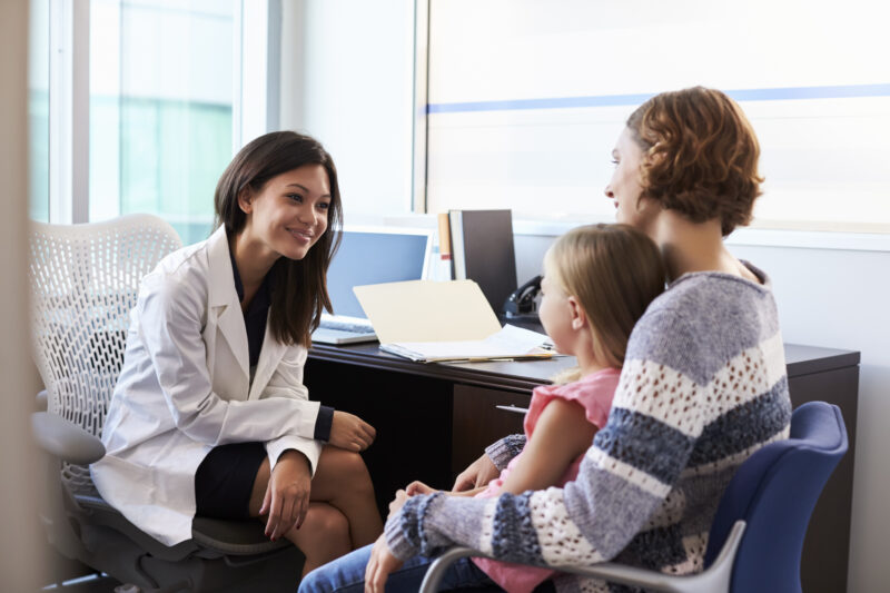 Pediatric provider consults with a mother and young child during a growth evaluation appointment