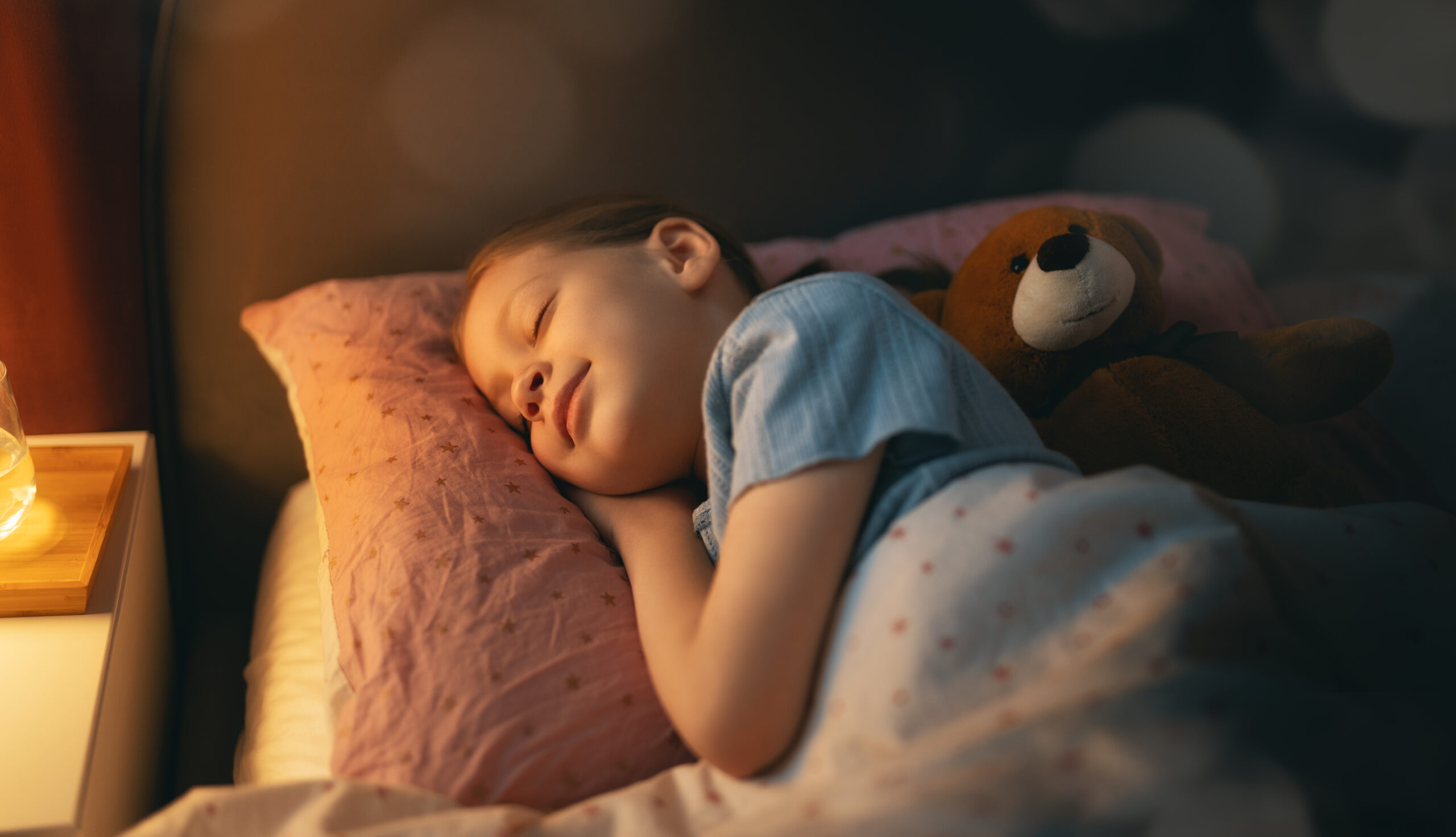 Child sleeping peacefully at night during the deep sleep window when growth hormone is released