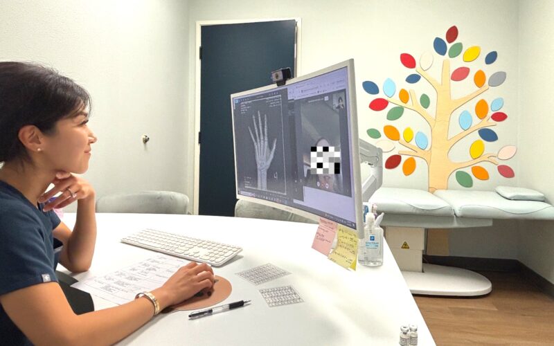 Yuri Kim FNP-C at I Grow Clinic conducting a telehealth consultation with bone age X-ray on screen