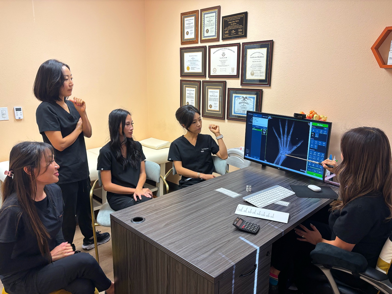 I Grow Clinic pediatric growth team reviewing a child's hand bone age X-ray on a monitor together